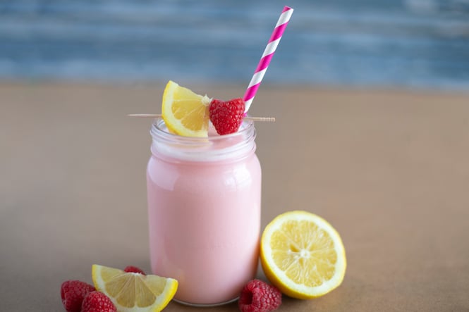 Raspberry Lemonade Cooler on a beach