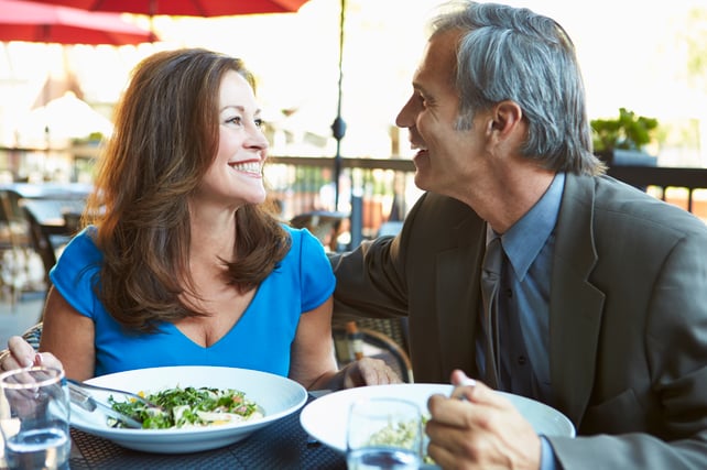 couple smiling at dinner together