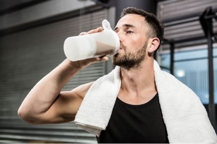 Man drinking protein shake as a meal replacement. 