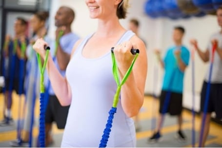 Women performing resistance training with her resistance bands
