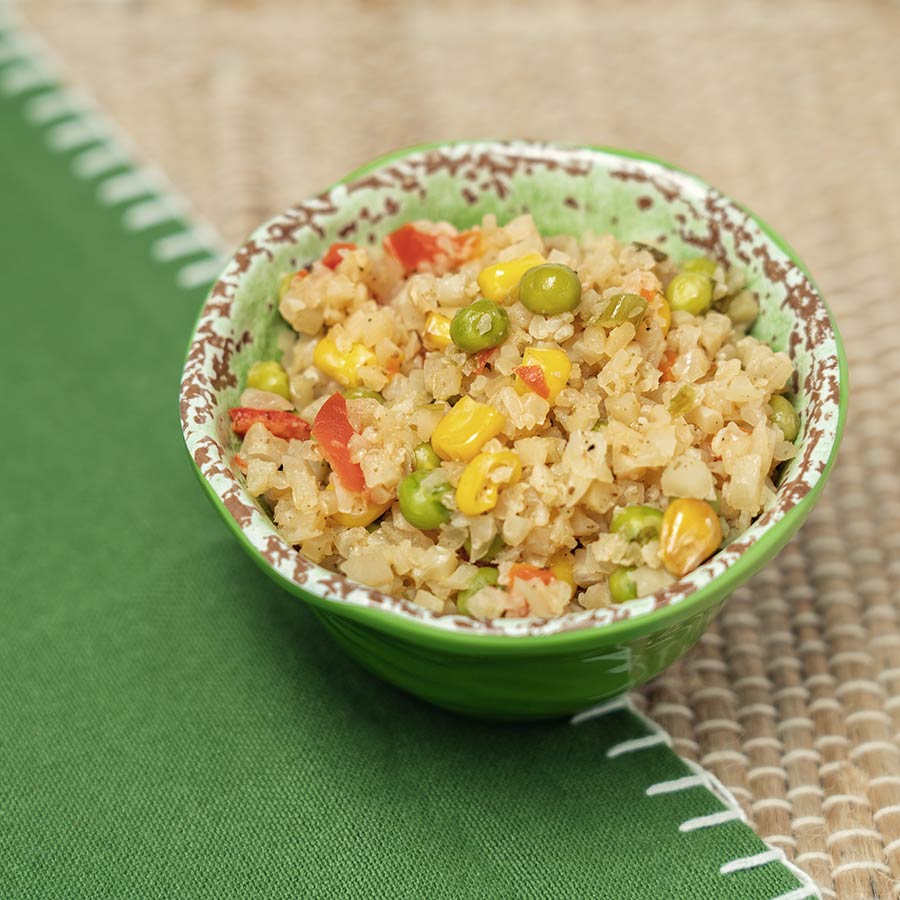 Small bowl of Cauliflower Fried Rice with peas and corn